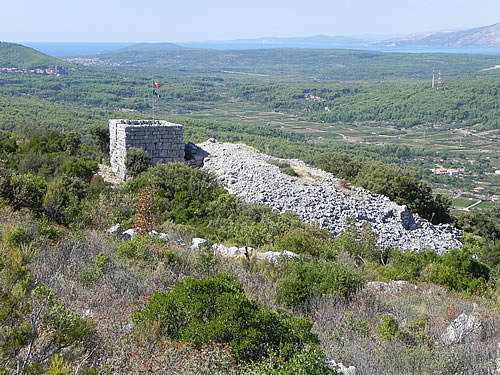 The restored tower and the rubble of the destroyed living quarters